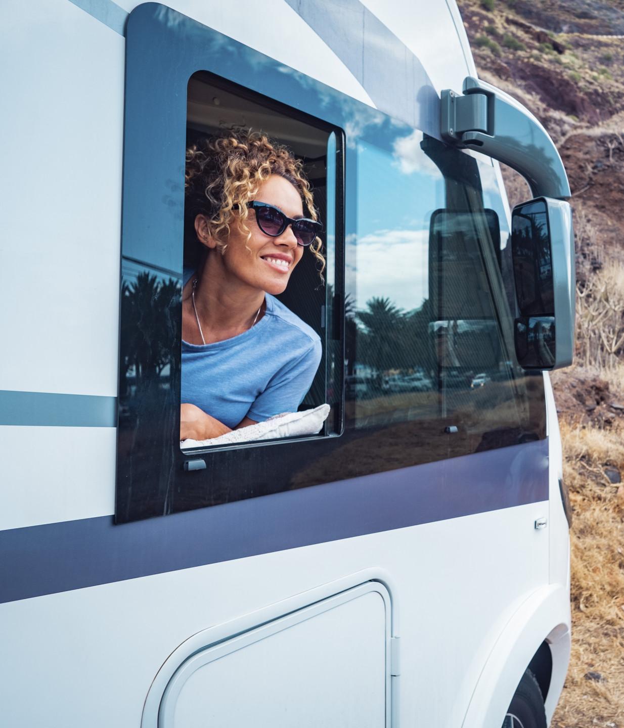 happy-adult-woman-smile-enjoy-travel-destination-inside-her-camper-van-cheerful-female-people-enjoy-travel-with-camper-van-concept-van-life-people-renting-motor-home-off-grid-parking